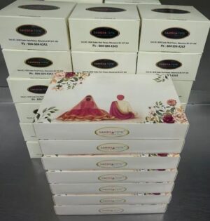 Stacked boxes with floral and logo design.