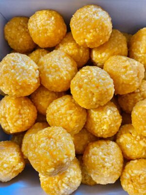 Round yellow sweets in a box.